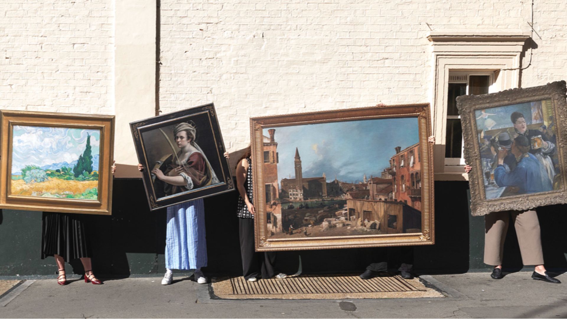an image of four people standing with four works of recreated art which are part of the initiative