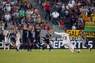 David Beckham scores a free-kick for La Galaxy against Vancouver in 2012.