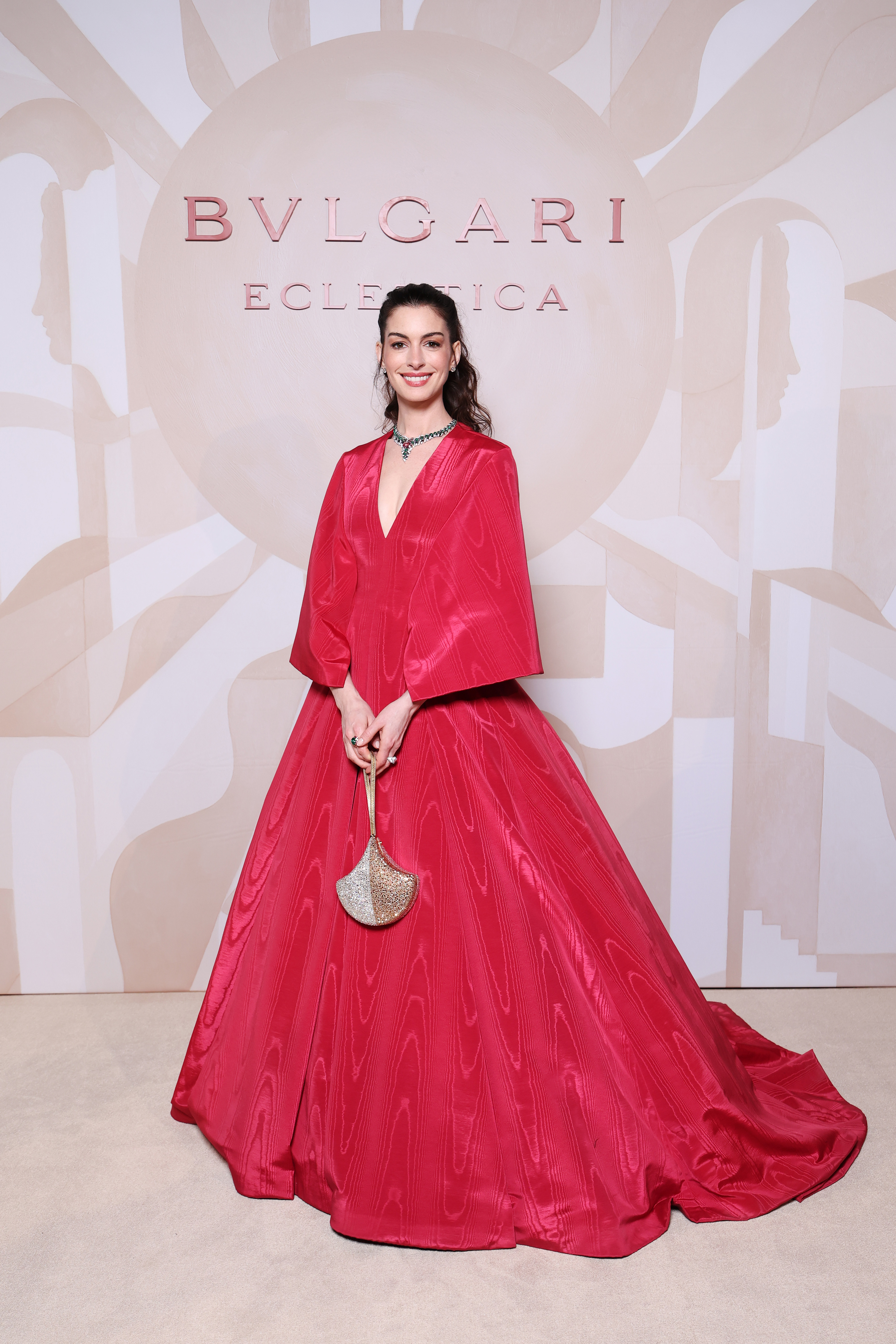 Anne Hathaway attended a Bulgari event in Milan dressed in a red ballgown and Bulgari jewelry