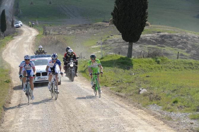 The early break rolls along on the gravel roads at Strade Bianche