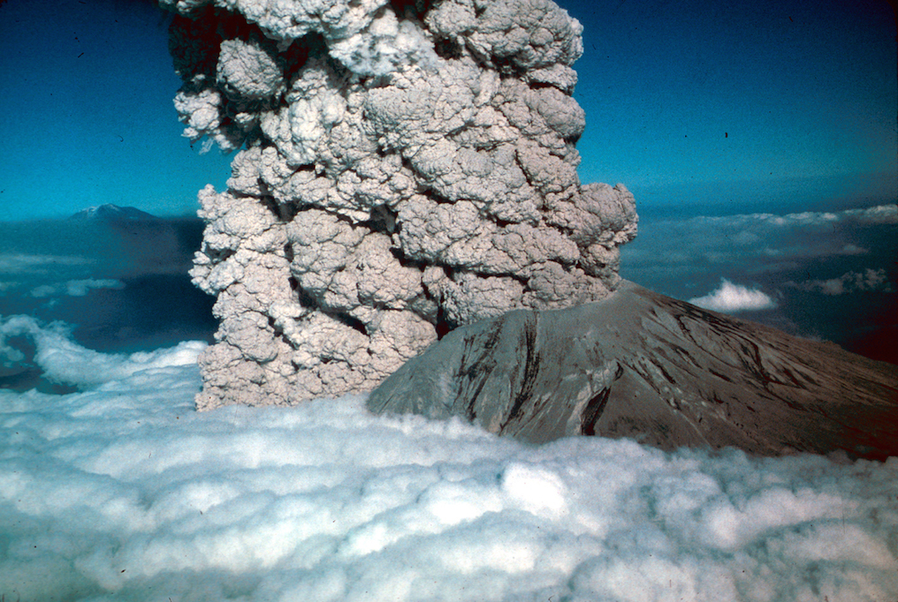 This photograph of the eruption of Mount St. Helens on July 22, 1980, shows a cloud from pyroclastic flow rising through cloud layer.