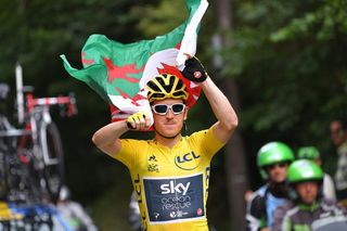 Geraint Thomas (Team Sky) carries the Welsh flag over his head during the last stage at the Tour de France