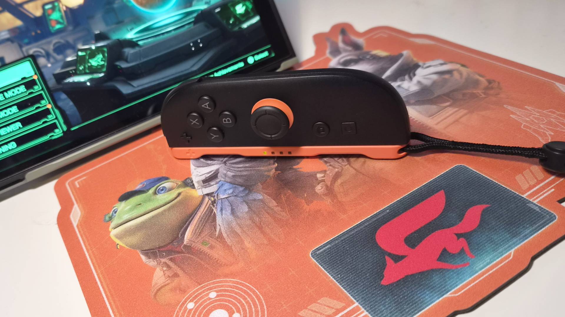 Close up of the right Switch 2 Joy-Con sitting on the Star Fox mousepad.