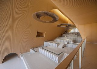 Inside the bamboo-lined library, with its cascading 'book mountain'