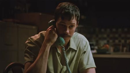 Bill Skarsgaard talking on the phone in Dead Man's Wire