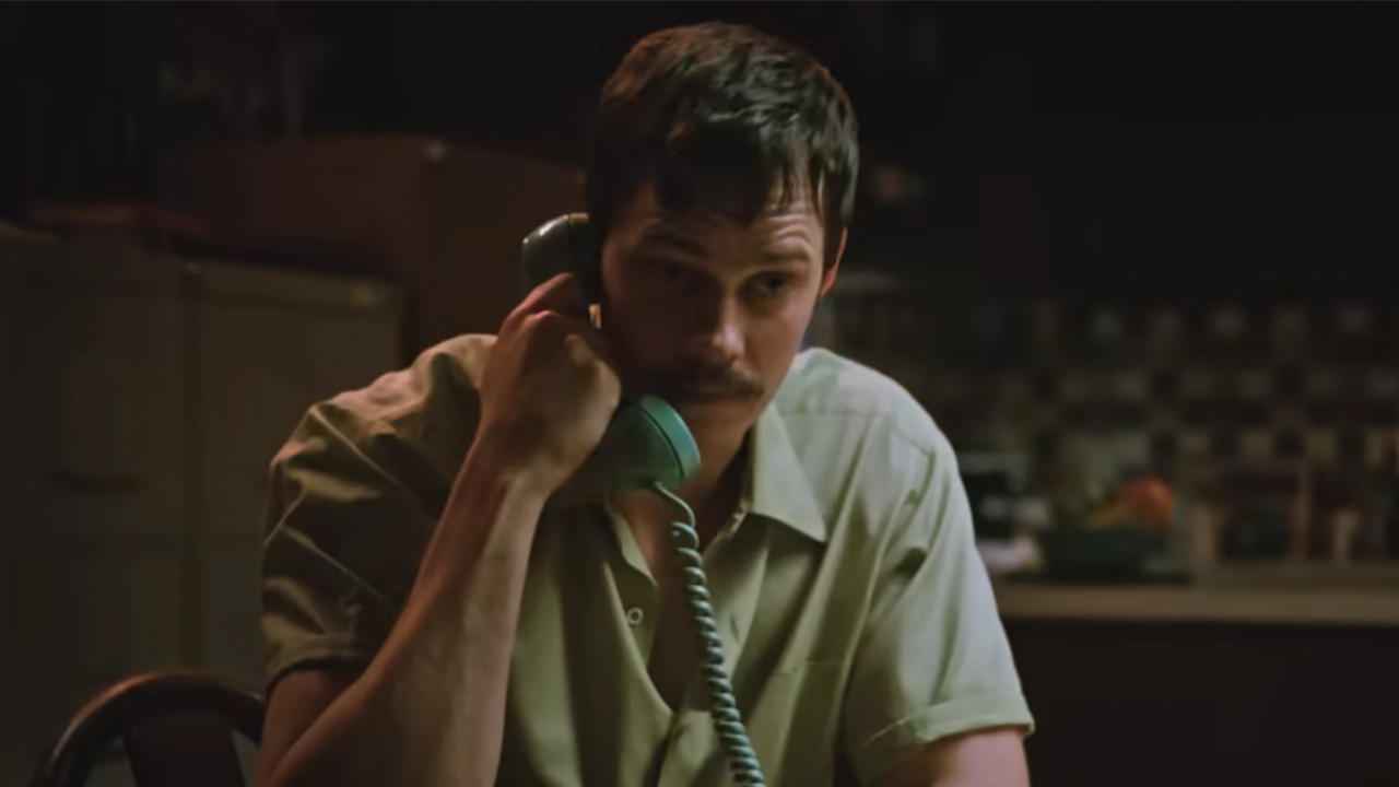 Bill Skarsgaard talking on the phone in Dead Man's Wire