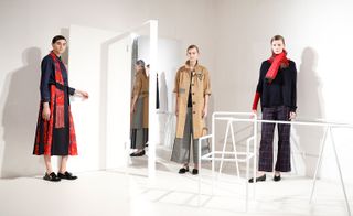 Models wear a range of trenchcoats, checkered wide-leg trousers and statement scarfs
