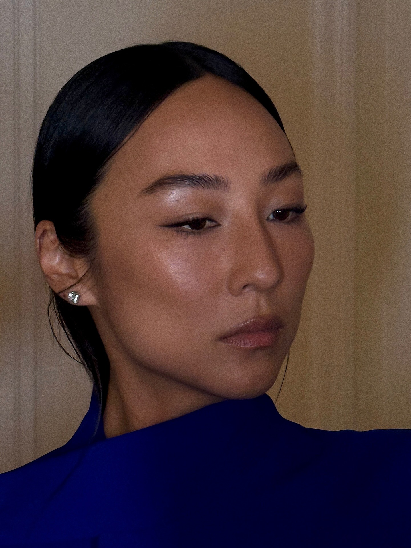 Greta Lee wearing a glowing makeup look