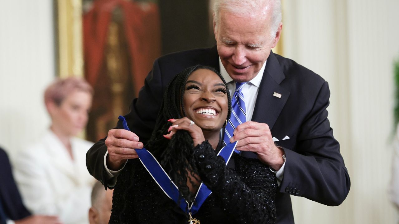 U.S. President Joe Biden presents the Presidential Medal of Freedom to Simone Biles, Olympic gold medal gymnast and mental health advocate, during a ceremony in the East Room of the White House July 7, 2022 in Washington, DC. President Biden awarded the nation&#039;s highest civilian honor to 17 recipients. The award honors individuals who have made exemplary contributions to the prosperity, values, or security of the United States, world peace, or other significant societal, public or private endeavors.