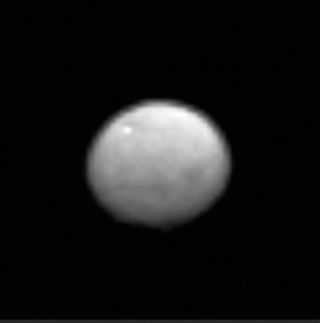 A zoomed-in view of the dwarf planet Ceres, seen from a distance of 238,000 miles (383,000 kilometers) by the Dawn spacecraft. The image hints at the presence of craters and other features of Ceres' surface. 
