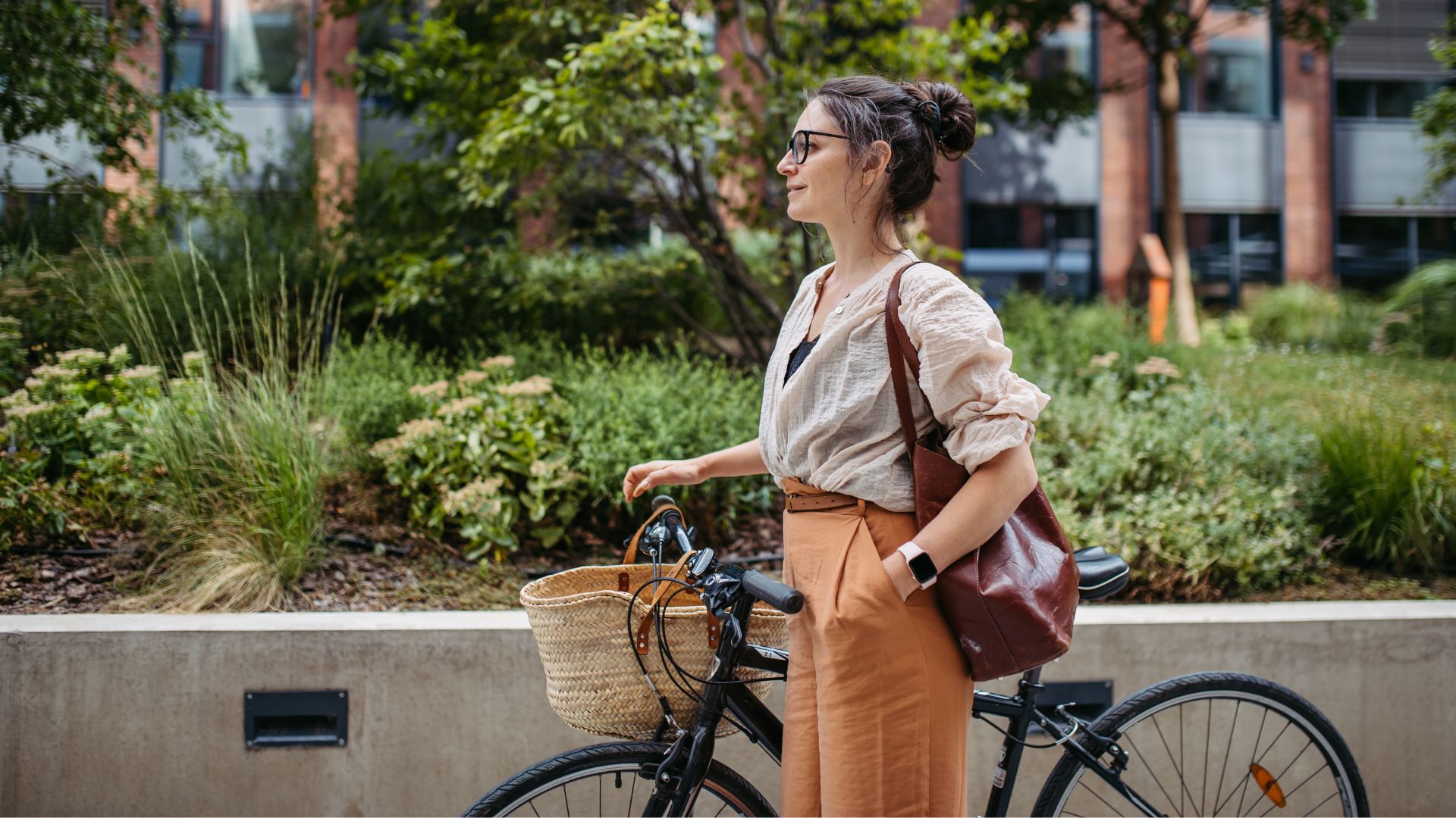 Woman riding a bike next to trees