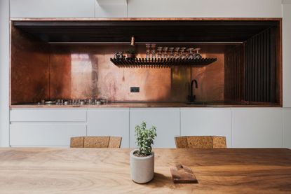 modern kitchen with copper countertop and backsplash