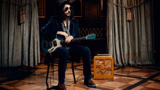 Mike Campbell of the Dirty Knobs, in hat, shades, guitar in hand