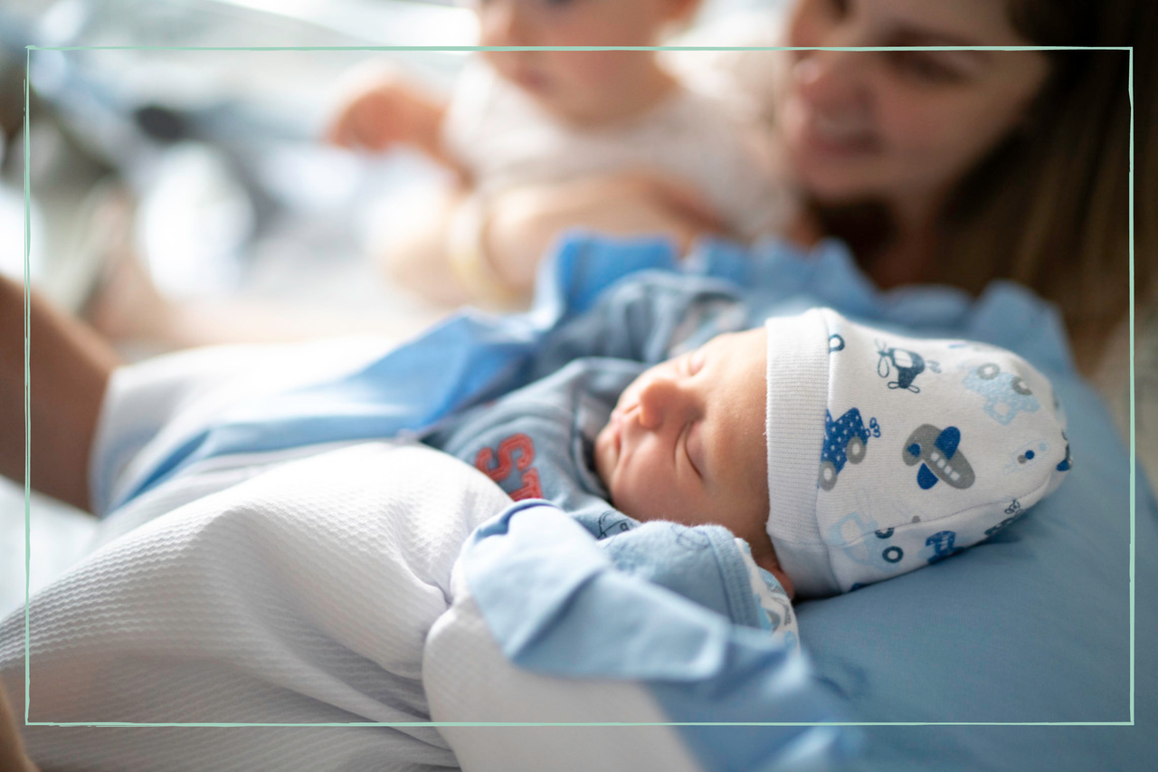 newborn baby next to mother