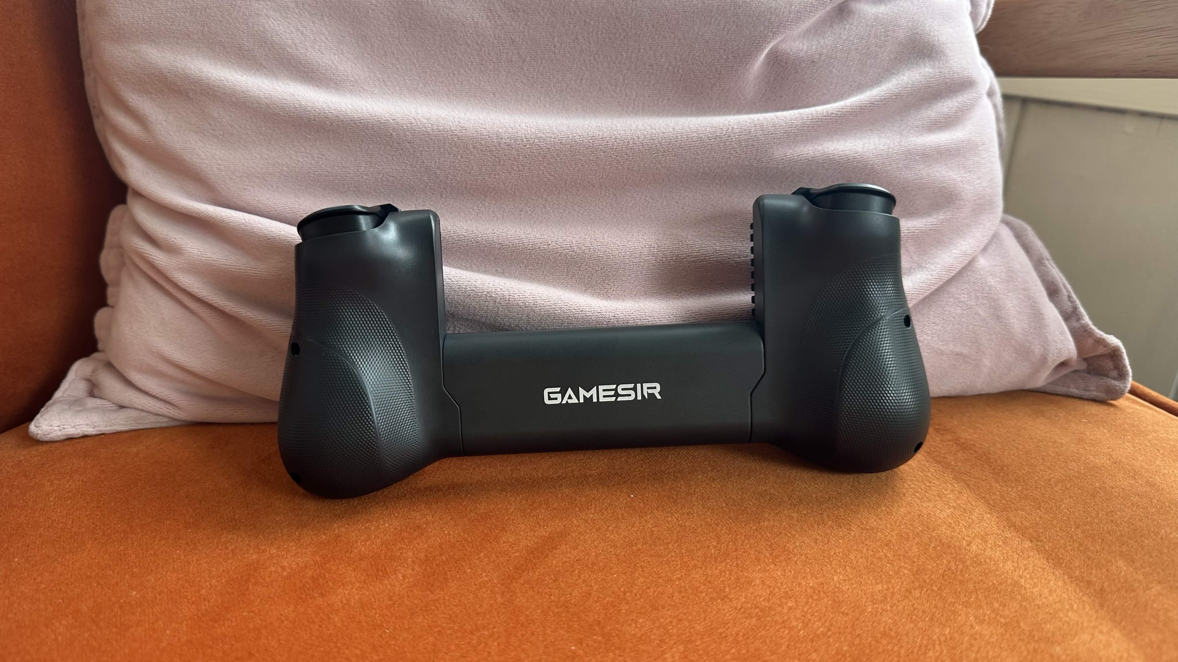 The back of the GameSir X5s controller on an orange sitting chair