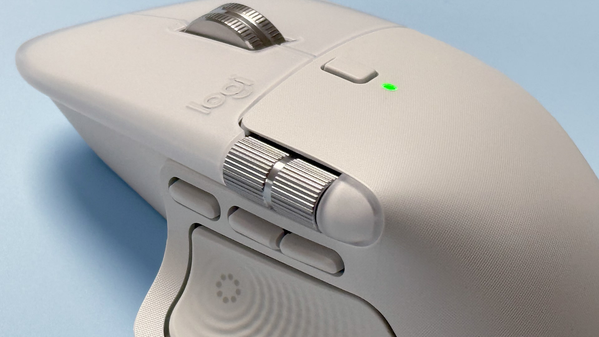 The Logitech MX Master 4 mouse against a blue background.