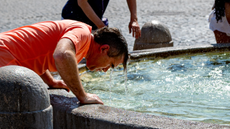 Man cools off at the Piazza del Popolo in Rome, Italy, during the heatwave