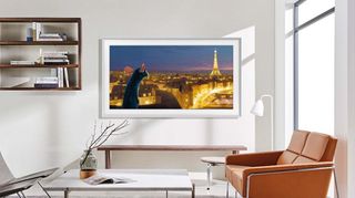 Samsung Frame TV X Disney collab showing Remy from Ratatouille looking at the eiffel towerr at night