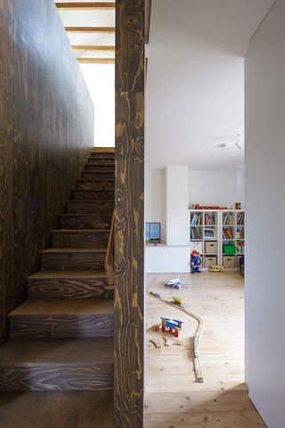 Wooden staircase leading up from children's room