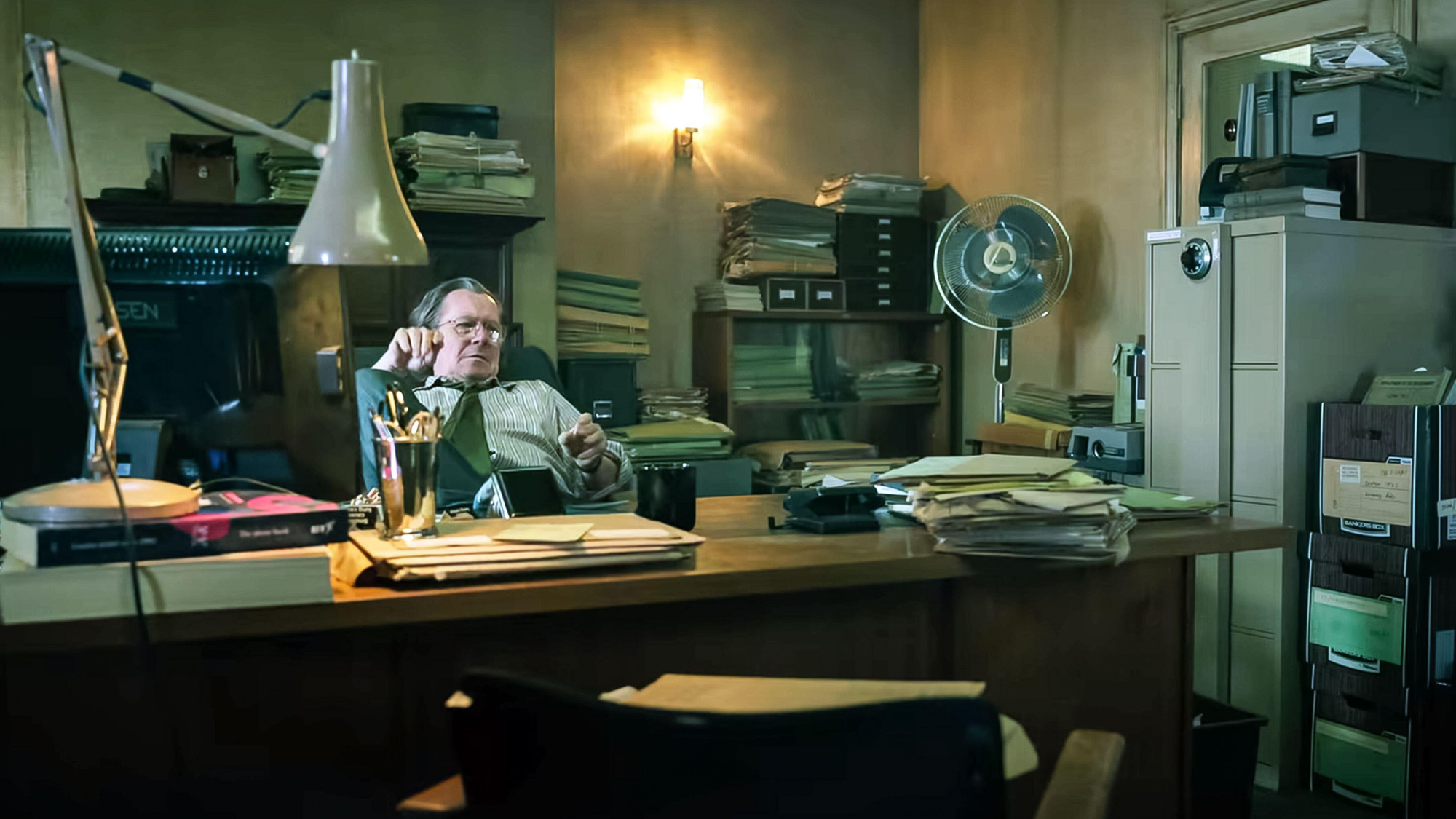 Gary Oldman at his desk in Slow Horses.