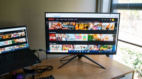 Monoprice Dark Matter 27-inch displaying Netflix on a desk next to a laptop and a window