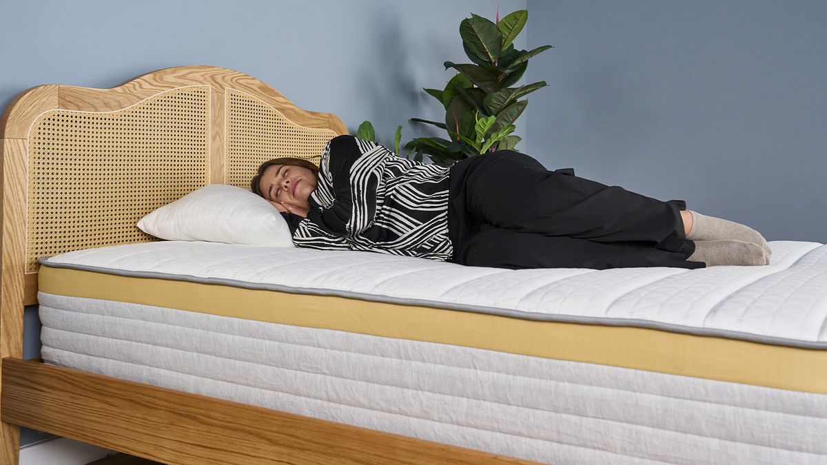 A woman lies on the Helix Dawn mattress in a side sleeping position