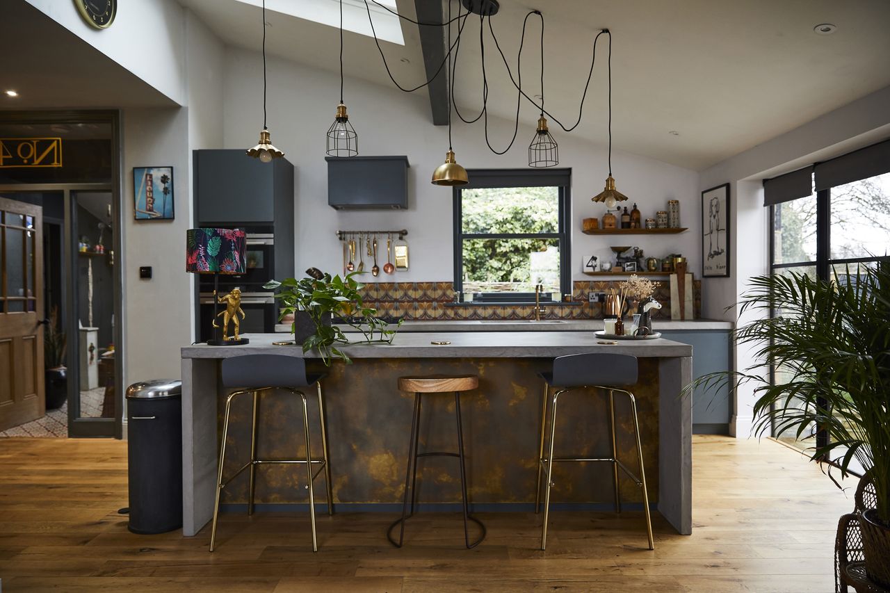 Kitchen with dark cabinets and island with bar stools