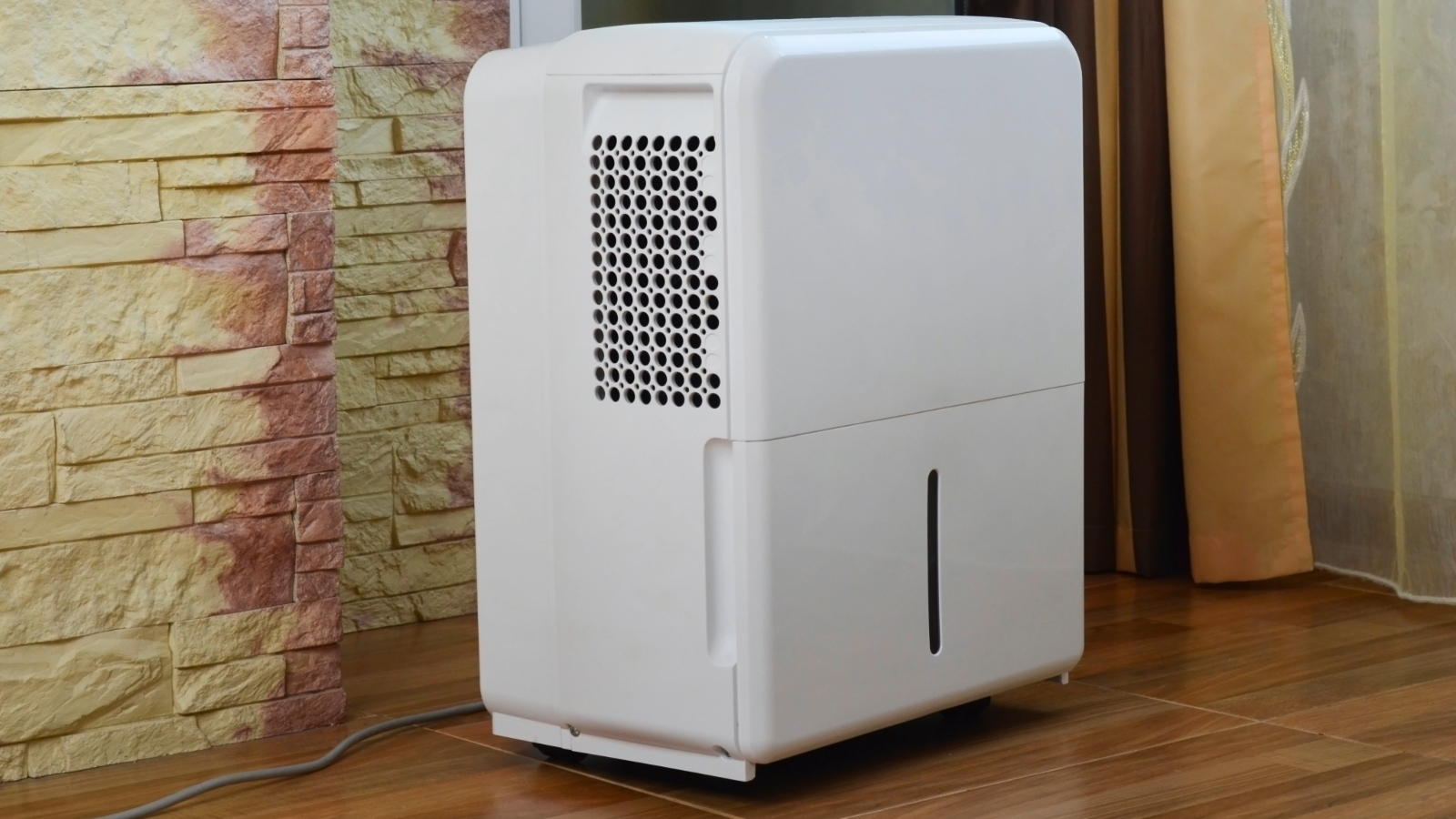 Dehumidifier in front of a brick wall