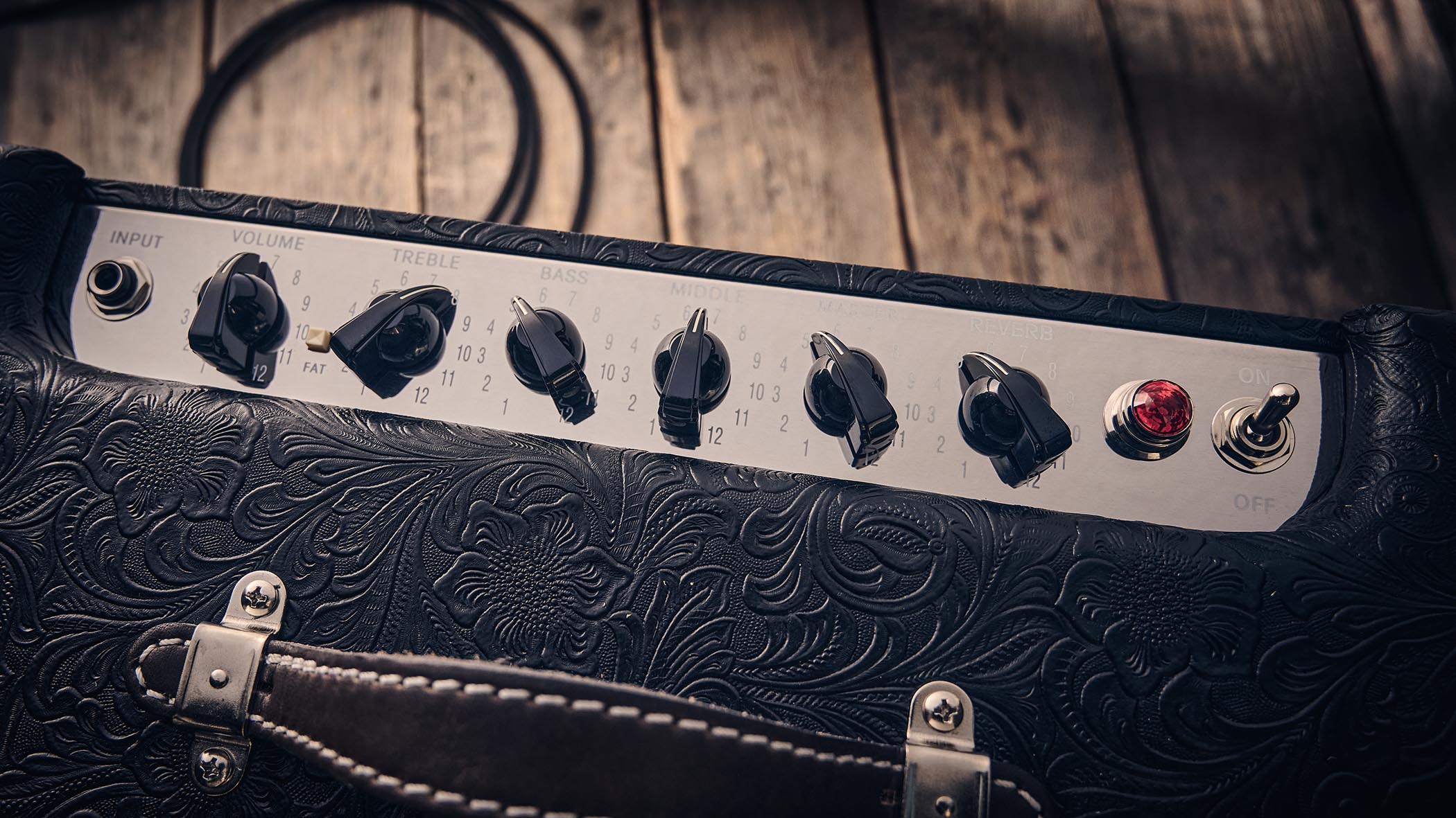 Fender Blues Junior IV 30th Anniversary: the classic combo is refinished with a touch of cowboy western flair, and is here photographed against some weathered floorboards in close-up