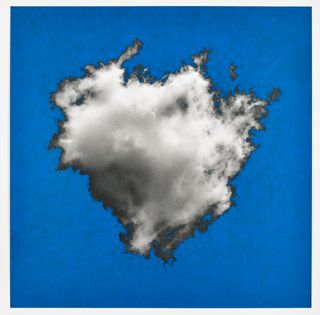 White cloud with grey outline and blue sky