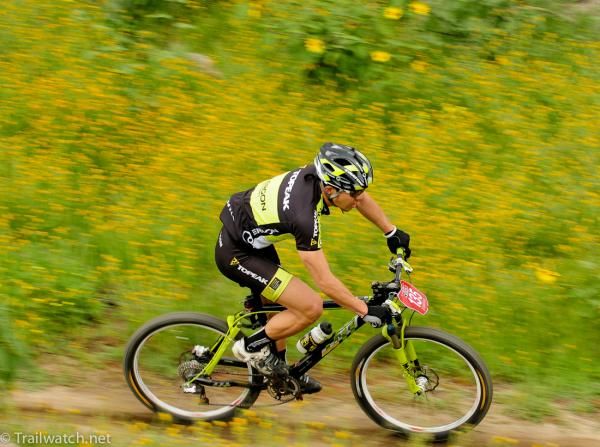 A Topeak Ergon rider passes by some spring flowers