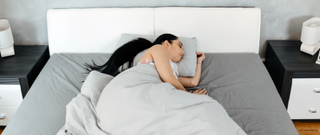 Woman sleeping on her side with a pillow under her neck