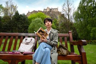 Sally Hawkins as Philippa Langley reading a book outside Edinburgh castle.