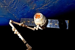 A Dragon cargo vehicle was separated from the space station on July 3 with help from two NASA astronauts and the orbiting outpost's robotic arm.