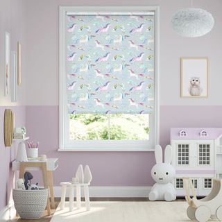 lilac and white girls nursery with patterned blind and dolls house