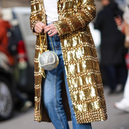 Fashion week attendee wearing sparkly jacket, sparkly Valentino bag and sparkly nails