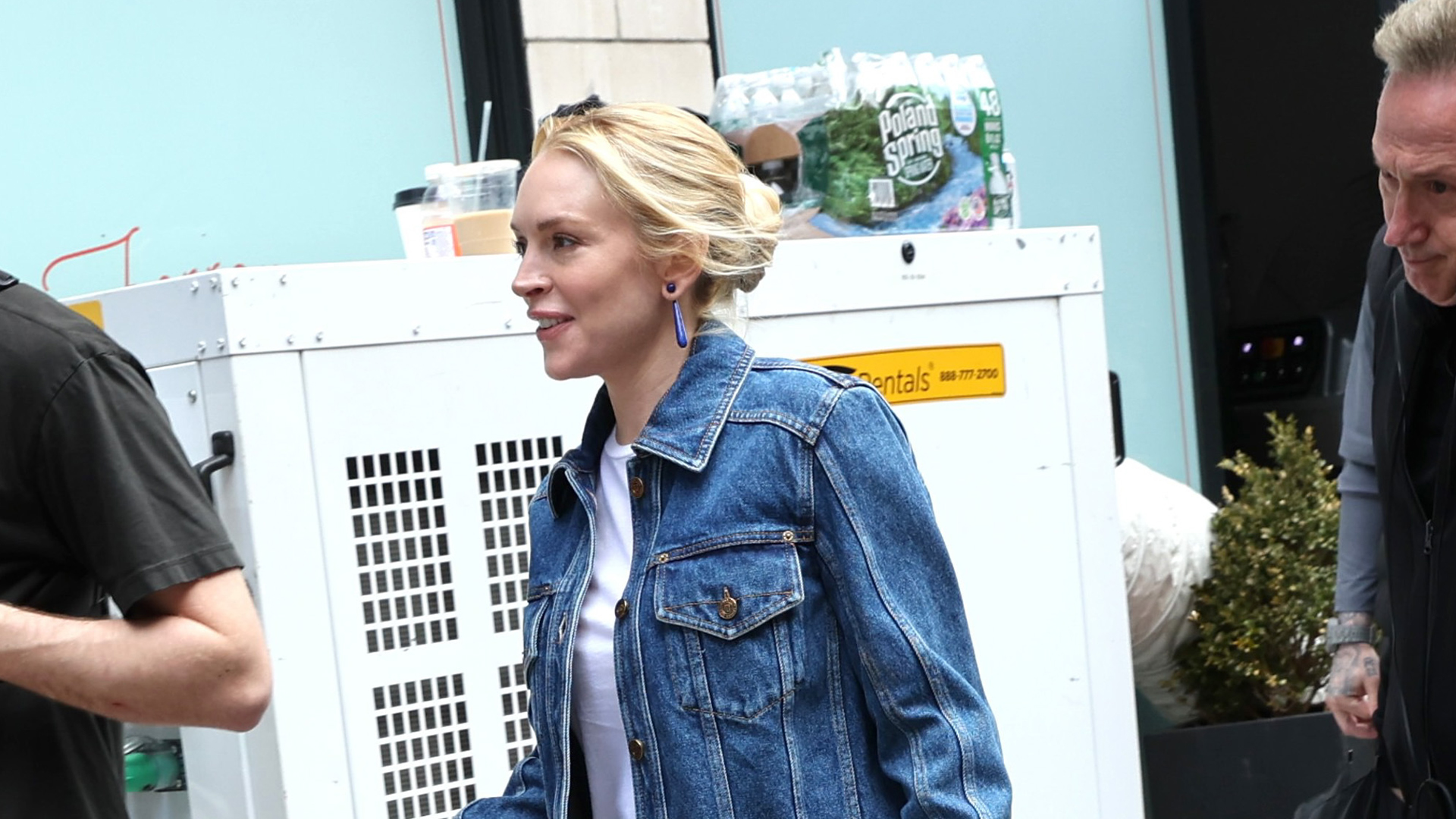 Lindsay Lohan wearing a denim jacket, denim jeans, black uggs, and brown Hermes bag