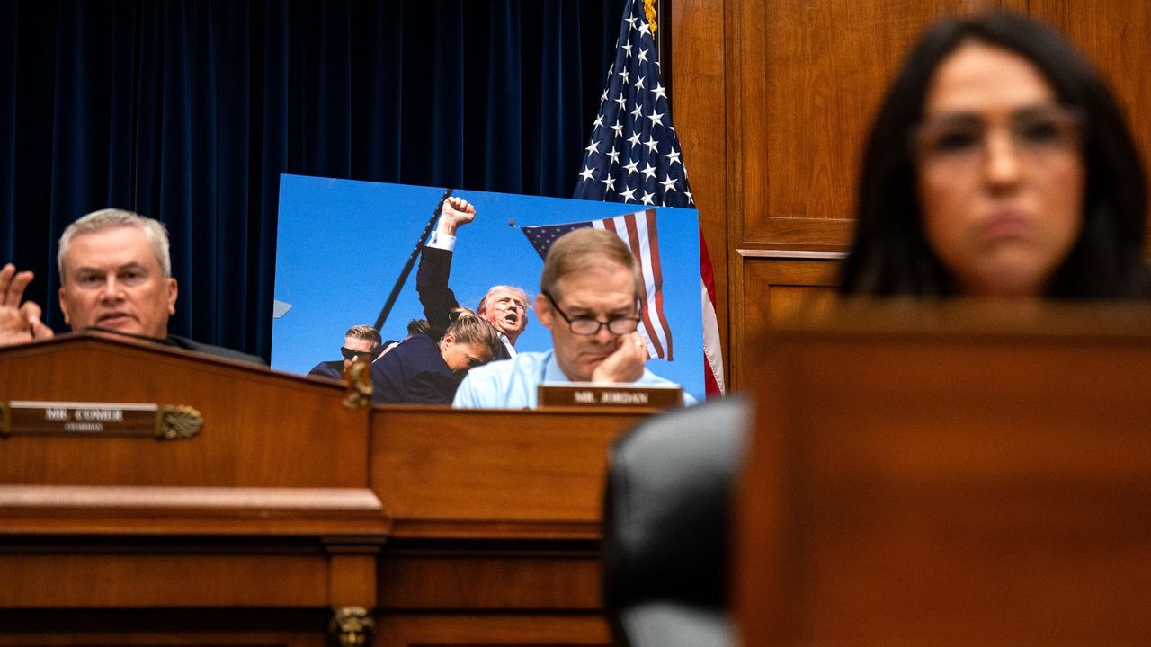 Evan Vucci&#039;s photograph of the attempted assassination of Donald Trump is seen in the background as Secret Service director Kimberly Cheatle testifies before the House Oversight and Accountability Committee