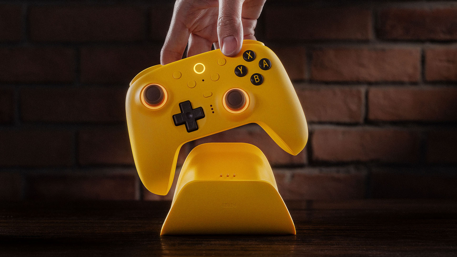 8BitDo Ultimate 2 controller in yellow being placed in its charging cradle