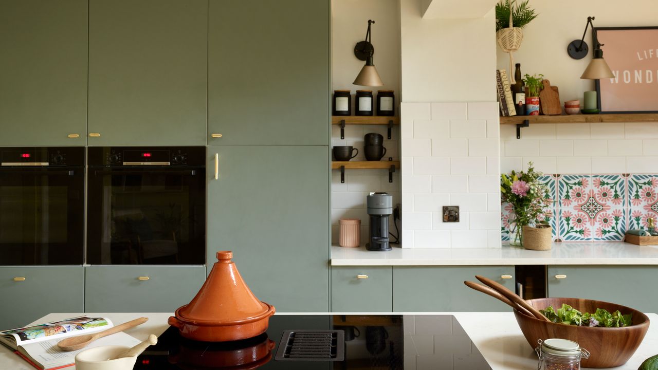 Kitchen with sage green painted kitchen cabinets and kitchen island