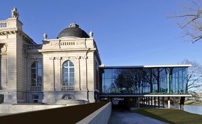 Exterior view of Liège’s Fine Arts Museum and the new concrete and glass La Boverie wing under a clear blue sky