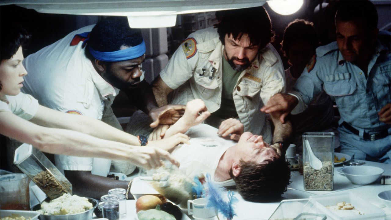 Chestburster: American actors Sigourney Weaver, Yaphet Kotto, Tom Sherritt, British actors John Hurt and Ian Holm in an iconic scene from "Alien," directed by Ridley Scott.