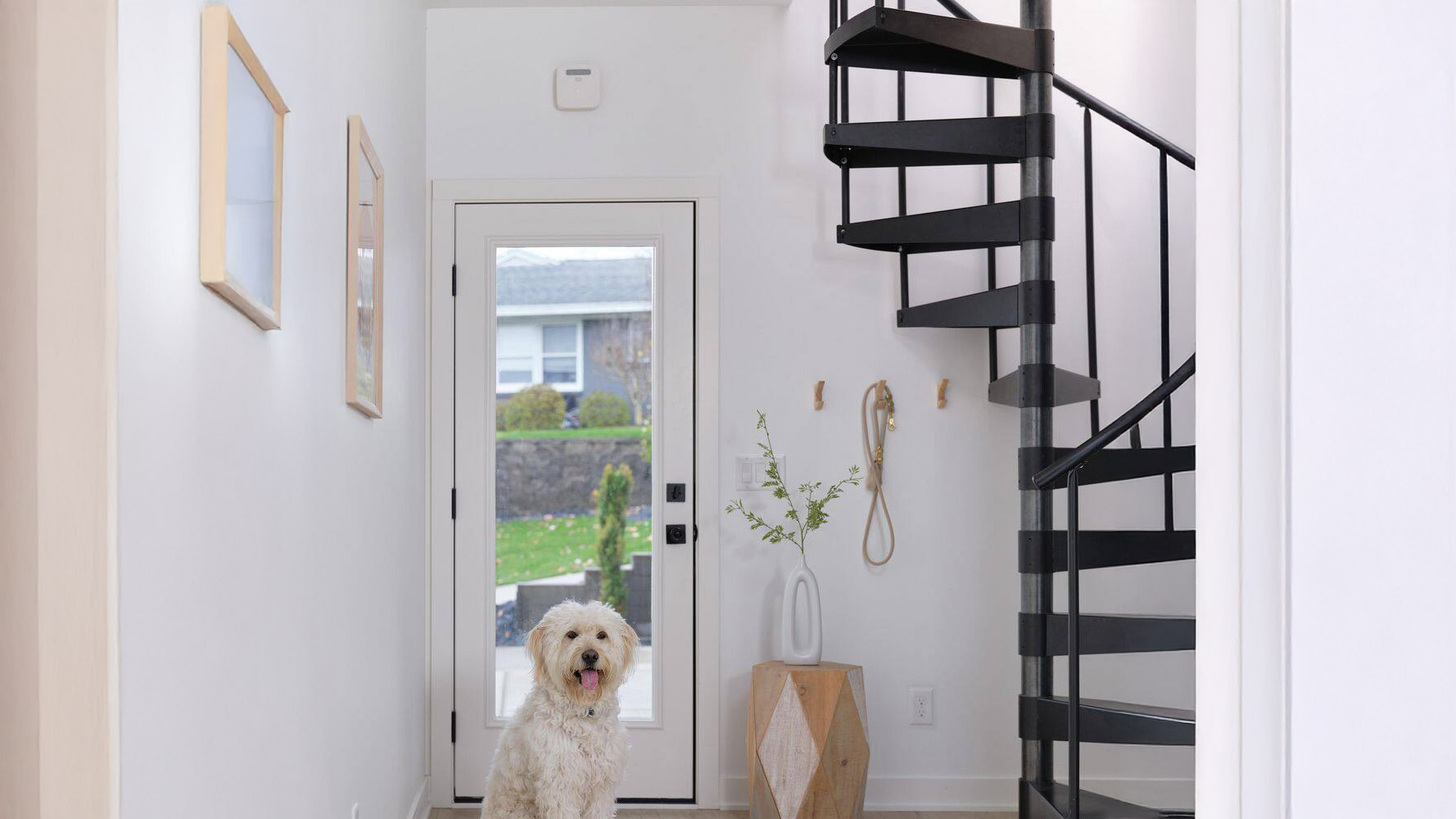 A Place smoke alarm mounted on the wall above a door