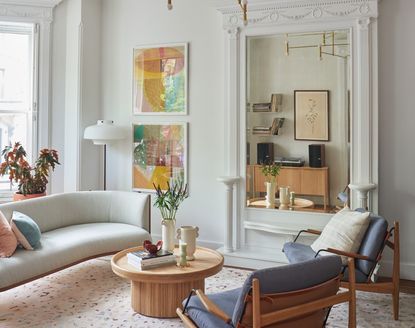 A living room with intricate crown molding and pared back decor