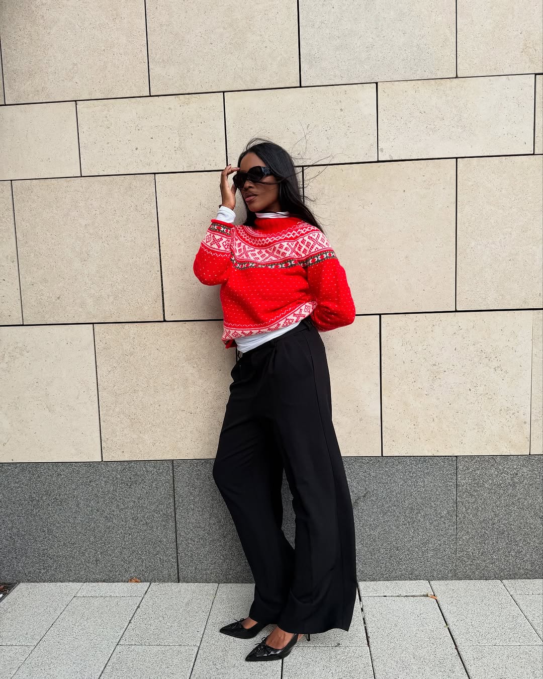 woman wearing chic holiday outfit idea 2025