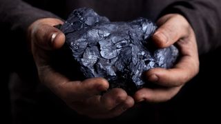 Hand with coal