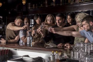 (From left to right) The characters Wolfgang (Max Riemelt), Capheus (Toby Onwumere), Sun (Bae Doona), Nomi (Jamie Clayton), Lito (Miguel Angel Silvestre), Kala (Tina Desai), Riley (Tuppence Middleton), and Will (Brian J Smith) raise their glasses for a toast in Sense8.