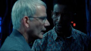 Campbell Scott and Mamoudou Athie stand off in the server room in Jurassic World Dominion.