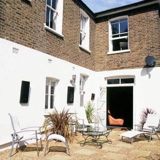 house exterior backyard with table and white chairs