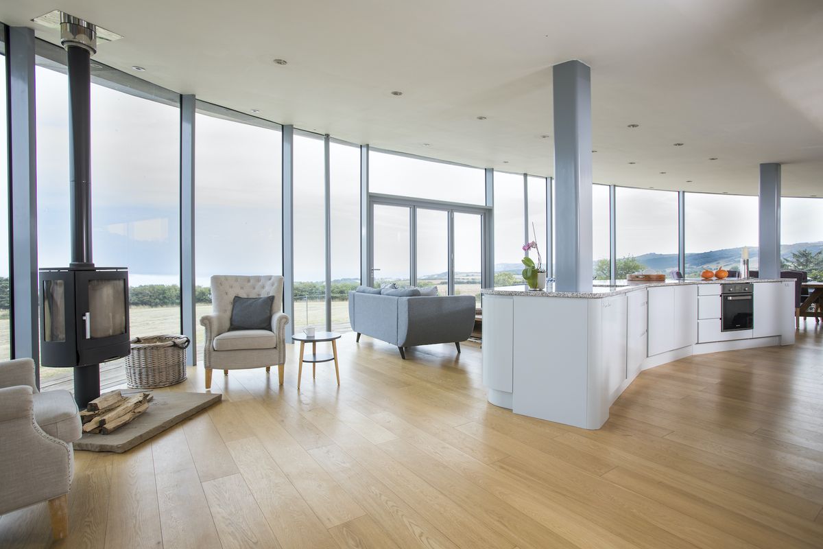 self build home with timber cladding and open plan space and glazing